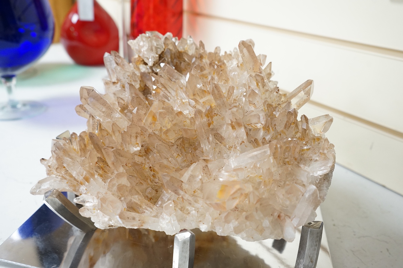 A large quartz specimen on bespoke chrome stand, stand 32cm wide x 26cm deep. Quartz 28cm wide x 27cm deep